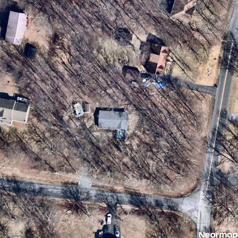 Residential roof and surrounding yard aerial view