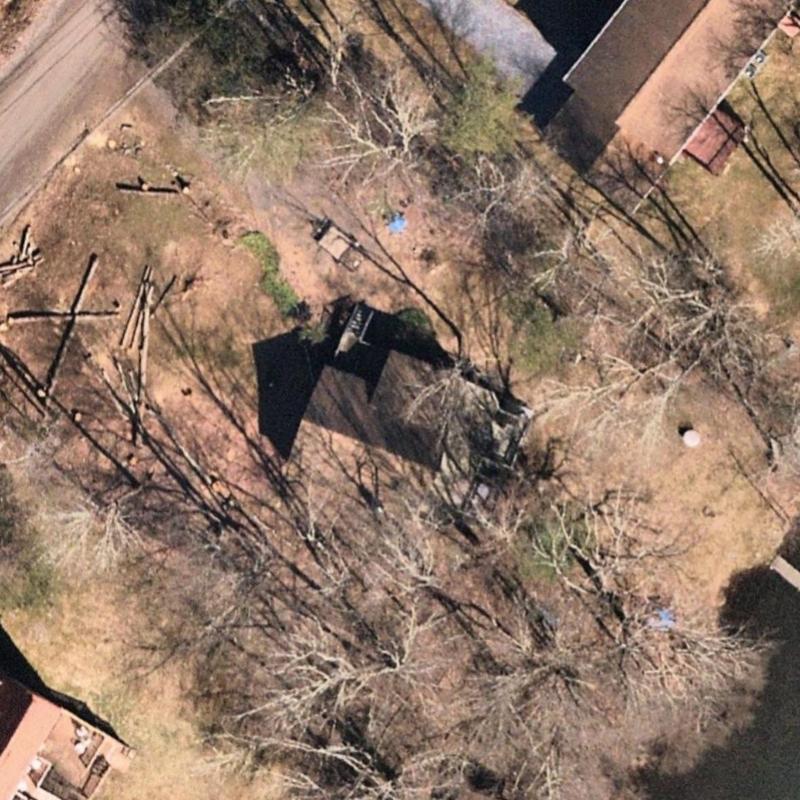 House roof and yard aerial view with trees and shadows