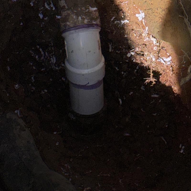 PVC sewer main pipe section in excavated soil