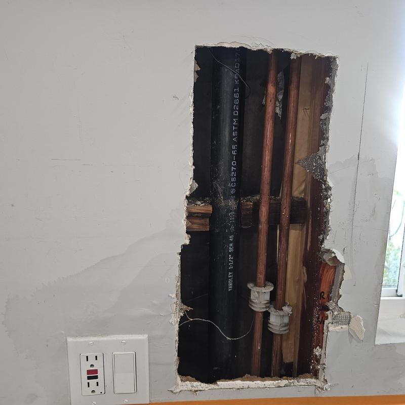 Copper water pipes inside opened wall cavity