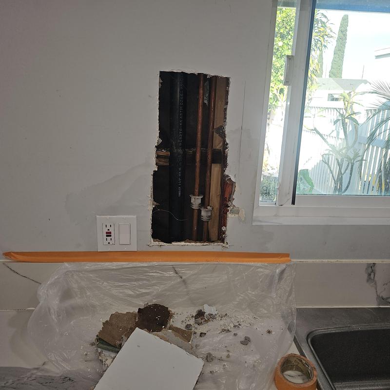 Copper water pipes inside wall leak repair area