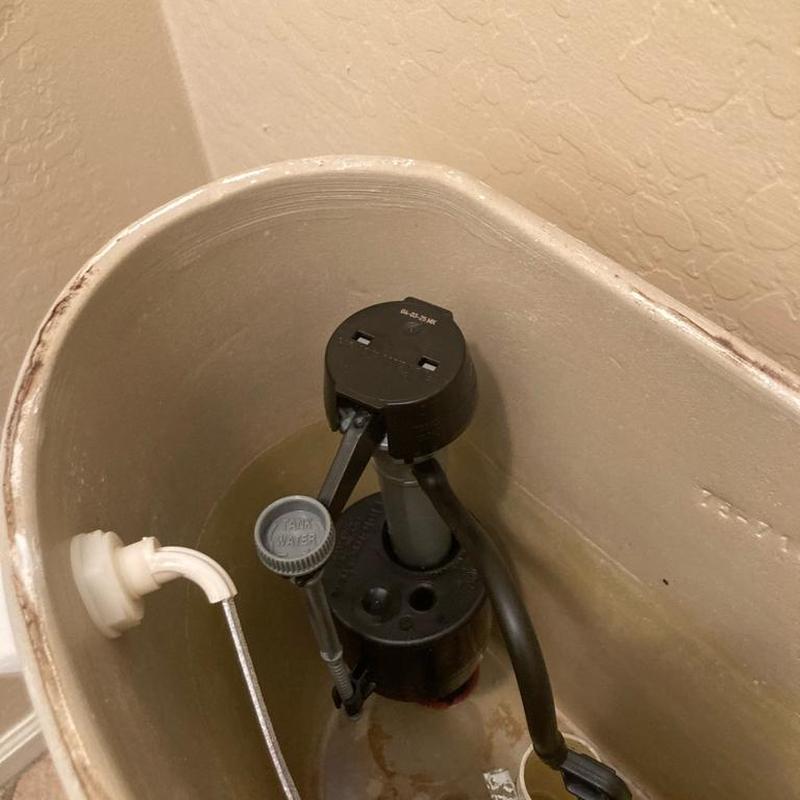Toilet fill valve inside tank with water level indicator
