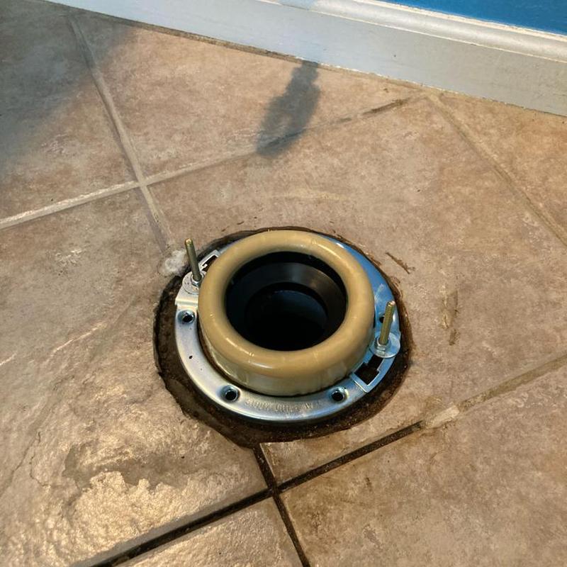 Toilet closet flange installed on tile floor