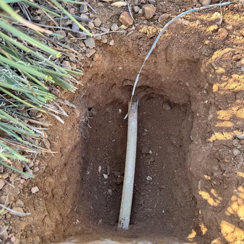 Main waterline excavation with pipe connection in soil