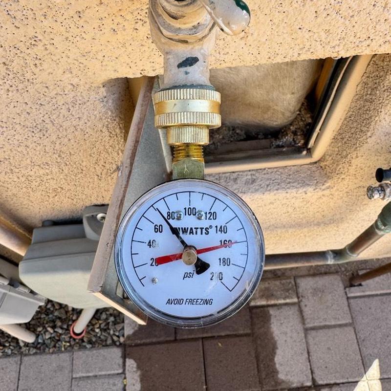 Pressure gauge on waterline near irrigation box