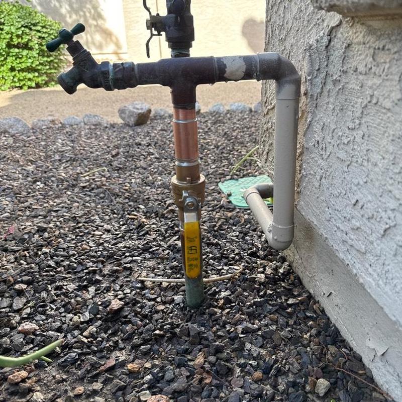 Main ball valve with yellow handle and pipe fittings