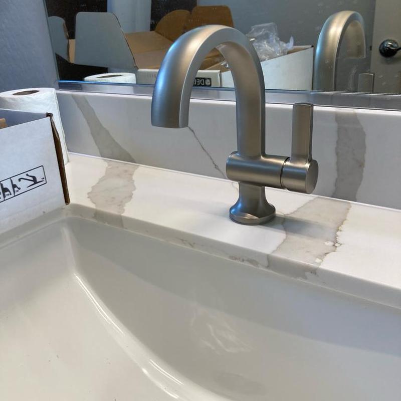 Delta single hole lavatory faucet on marble sink