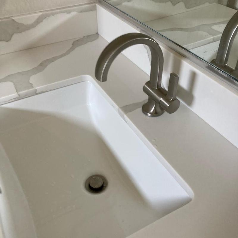 Delta single hole lavatory faucet on white counter