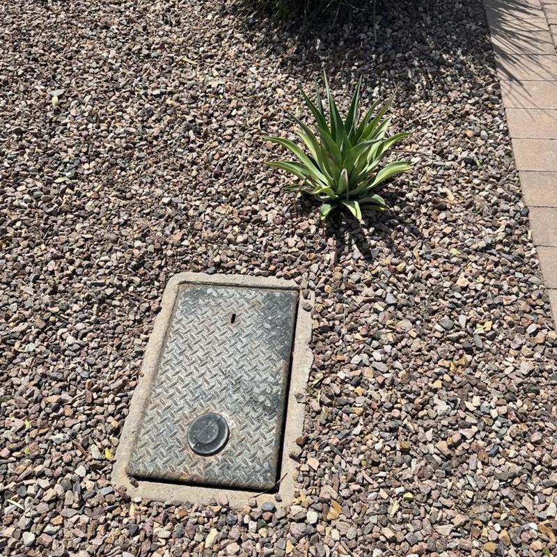 Pressure vacuum breaker valve underground cover in gravel yard