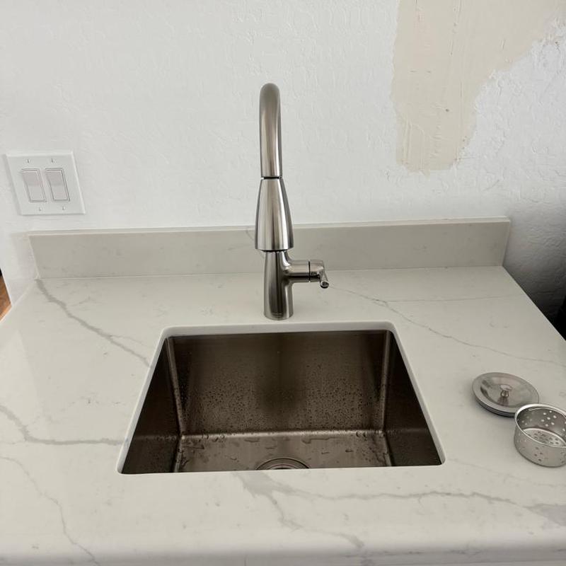 Kitchen sink with faucet and ABS drain fittings installed