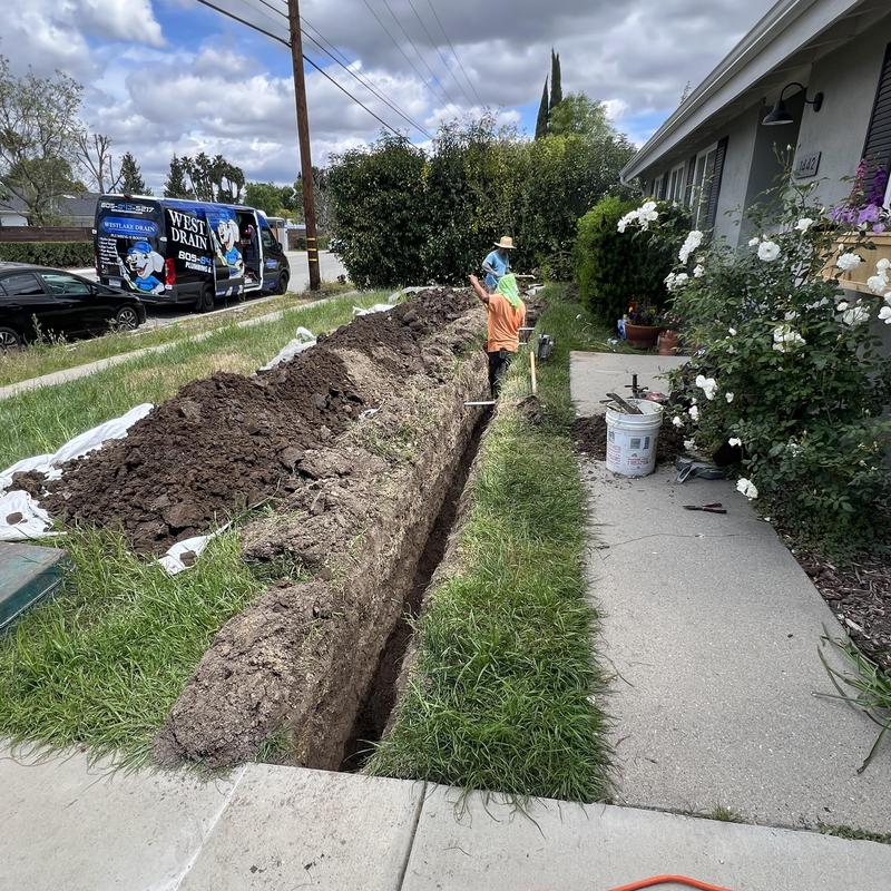 Drainage trench excavation across front yard in Thousand Oaks