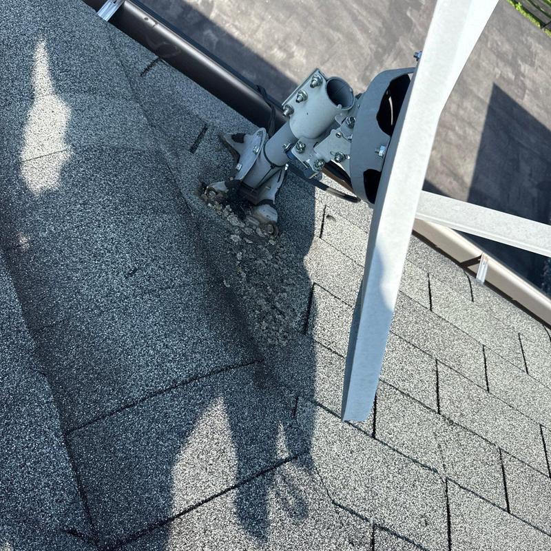 Roof shingles damaged near satellite dish mount