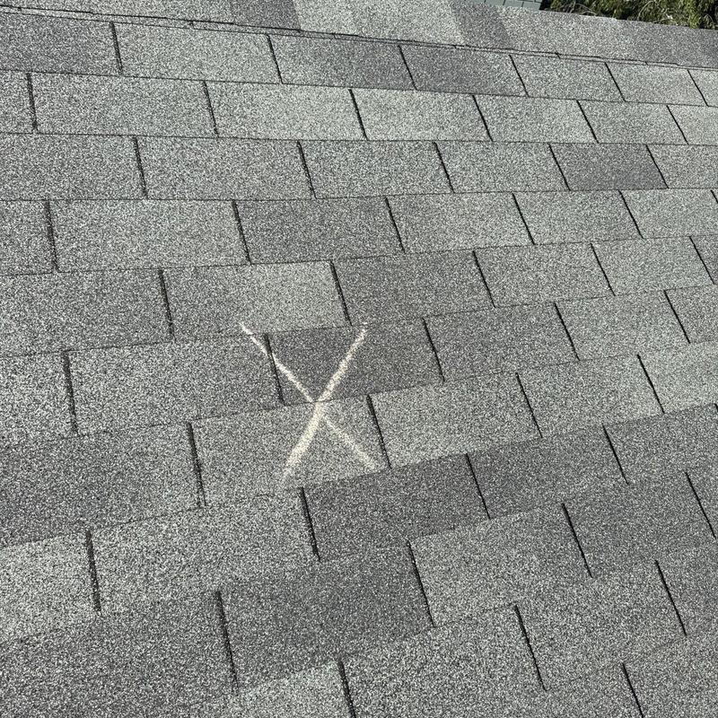 Asphalt shingles with marked hail damage