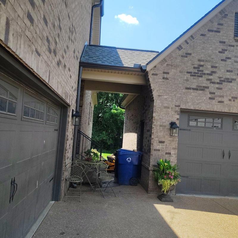 Gutter downspout and roof edge at brick home