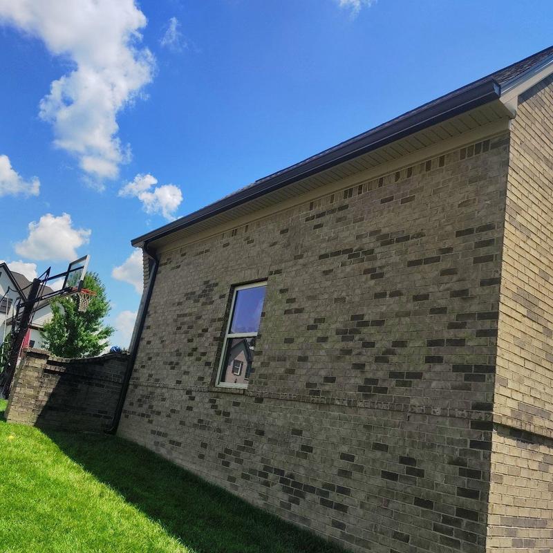 Gutter and downspout on brick house exterior
