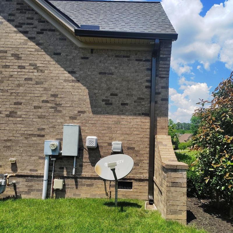 Satellite dish installation on brick exterior wall