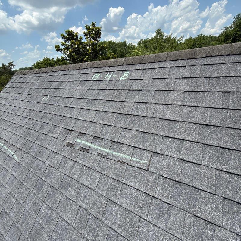 Asphalt shingles roof with hail damage markings
