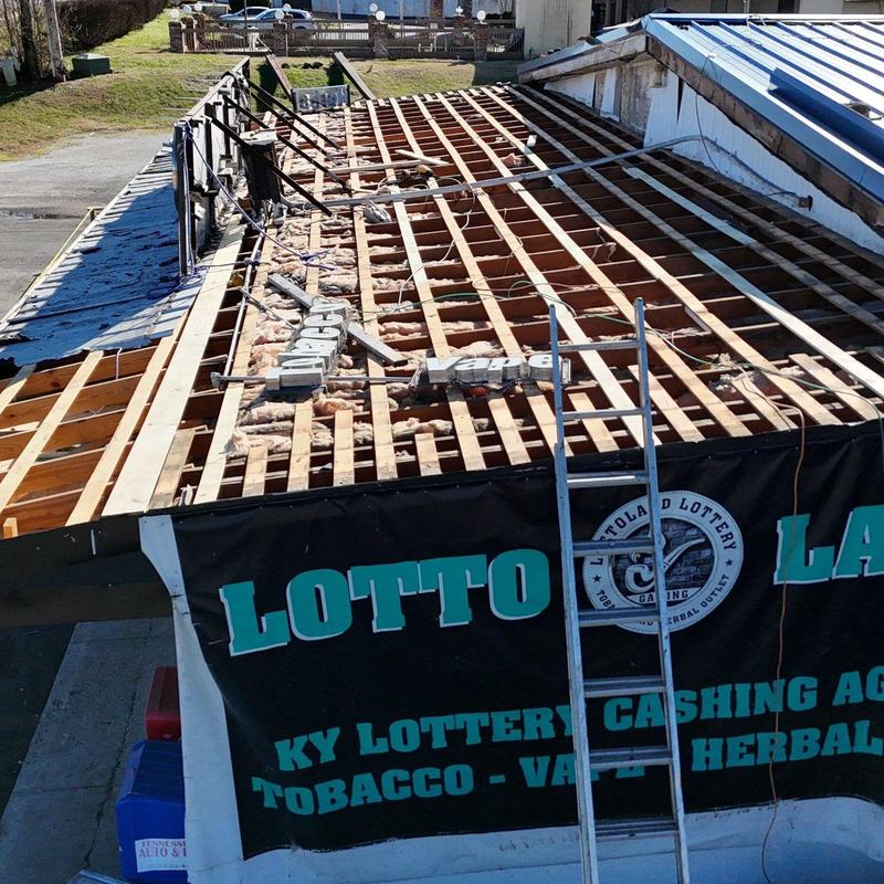 Commercial roof decking exposed with ladder on side