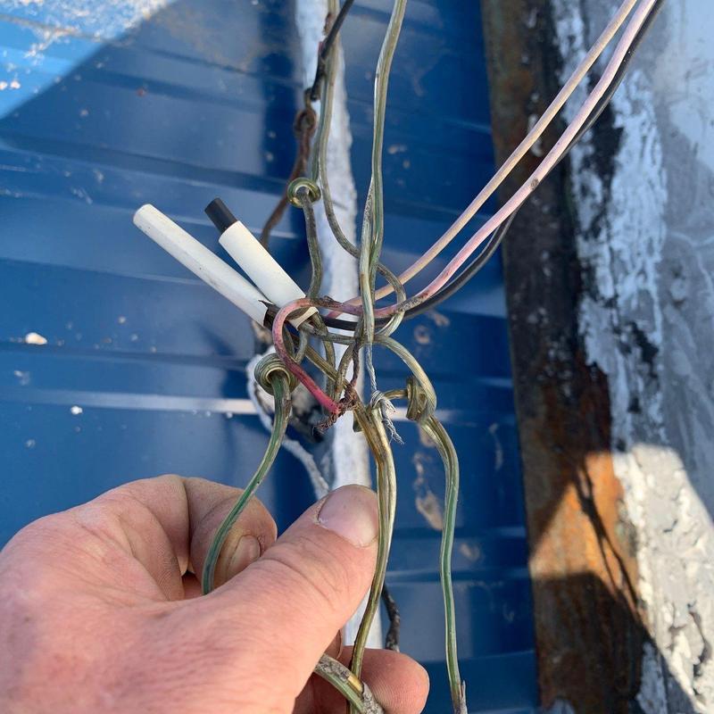 Electrical wiring with damaged insulation on metal roof