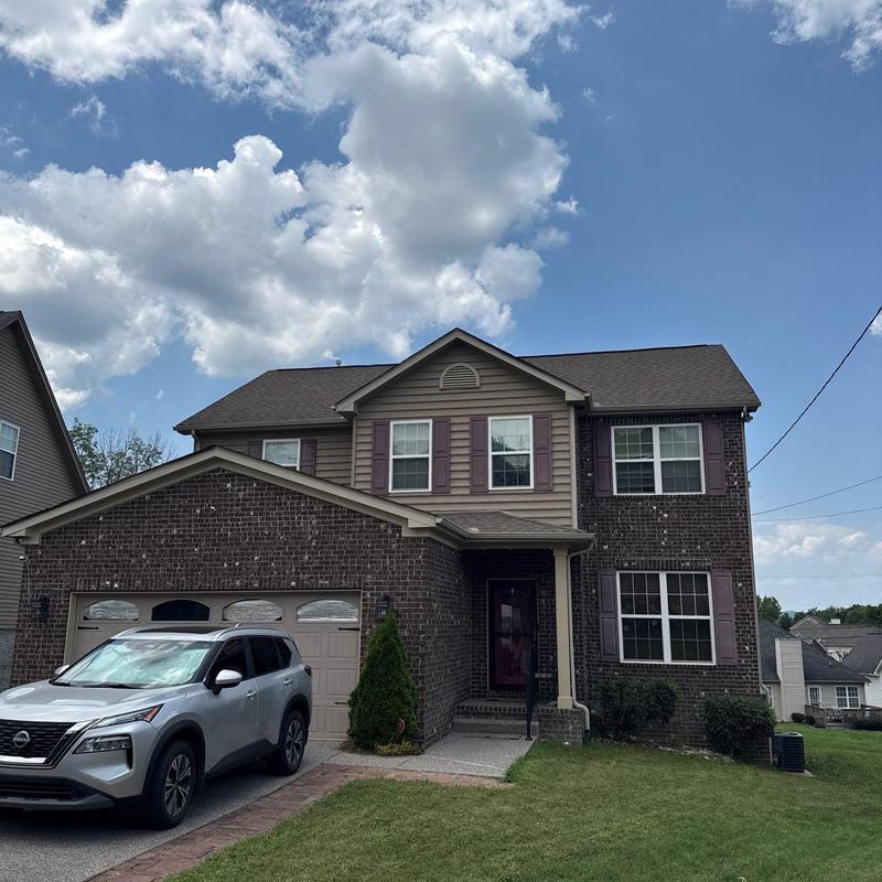 Roof shingles and flashing with hail damage on house