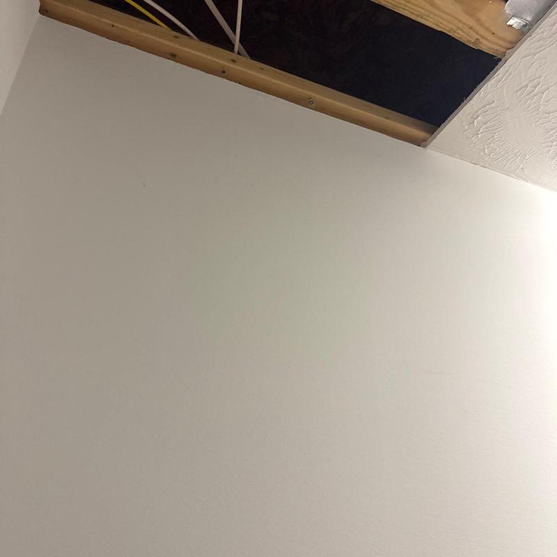 Ceiling drywall with exposed framing and wiring