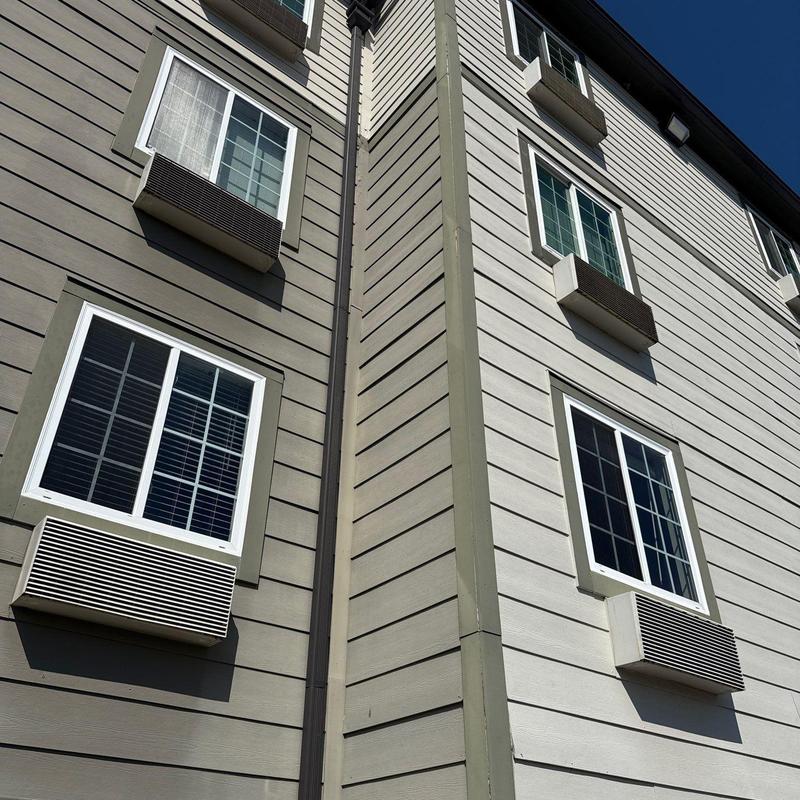 Window air conditioning units on apartment building exterior