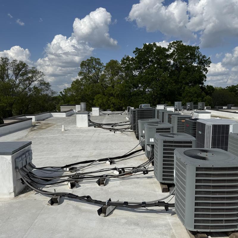 Rooftop HVAC units and electrical wiring on flat roof