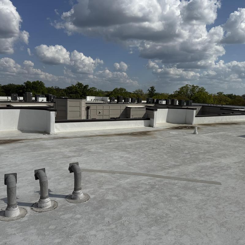 Flat roof membrane with vent pipes on townhome complex roof