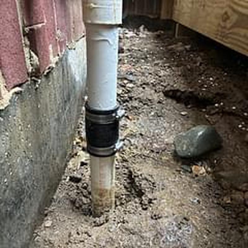 PVC discharge line on sump pump with coupling clamp