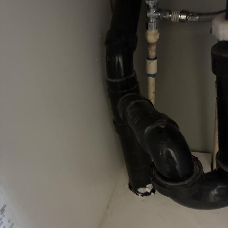 Bathroom drain pipe and supply valve connections under sink