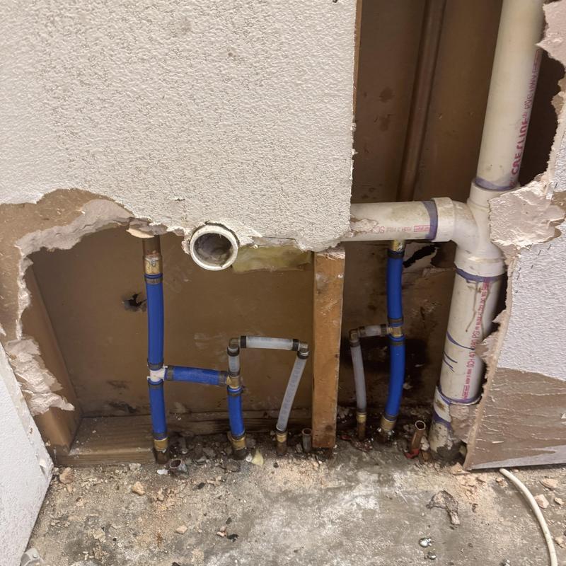 PEX water line manifold with copper fittings inside wall