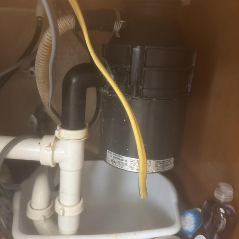 Garbage disposal unit and drain pipes under sink