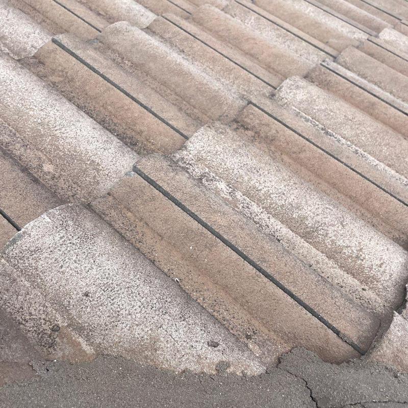 Concrete tile roof with storm damage and cracking