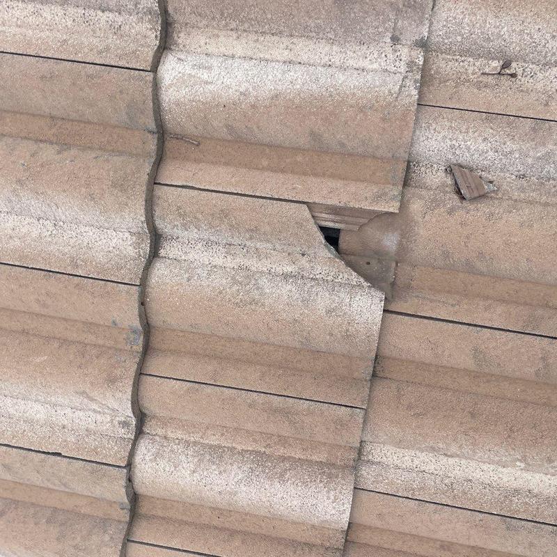 Concrete tile roof with cracked and broken tiles