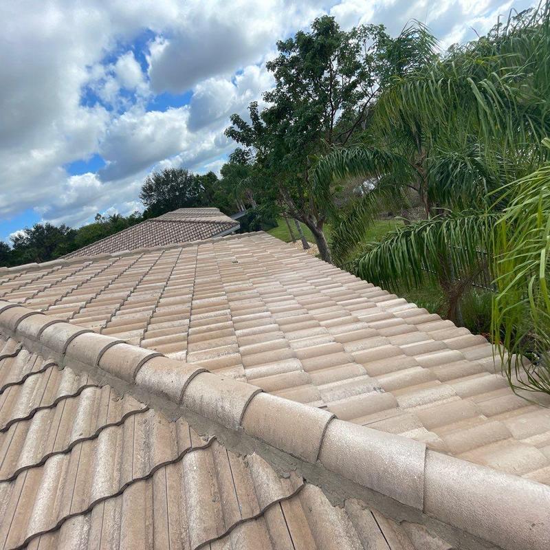 Concrete tile roof with storm damage and shifting tiles