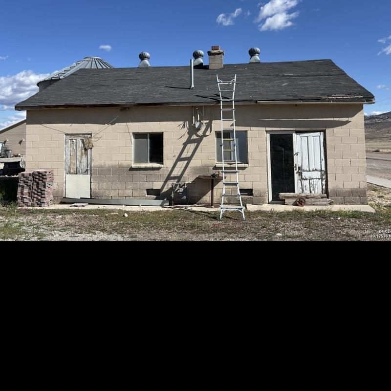 Asphalt shingle roof with ladder set up for inspection