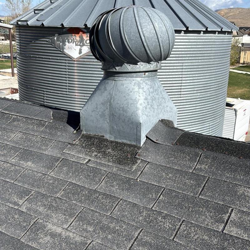 Asphalt shingle roof with metal turbine vent