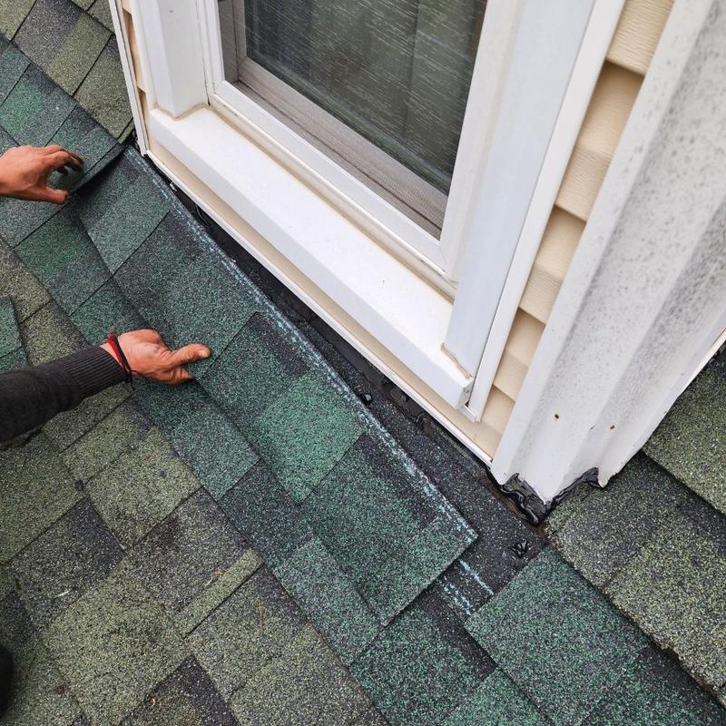 Corner window roof flashing with shingle repair in progress