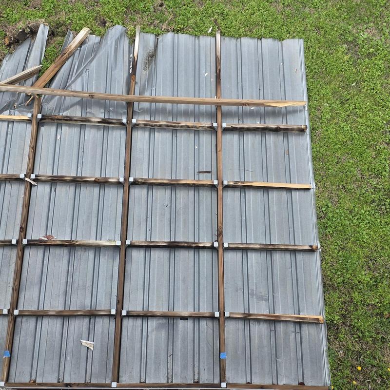 Metal roofing panel with hail and wind damage