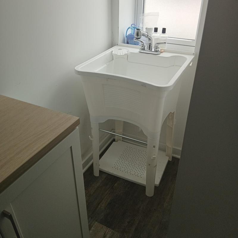 Utility sink installation with faucet and soap dispensers Utility sink installation with faucet and soap dispensers