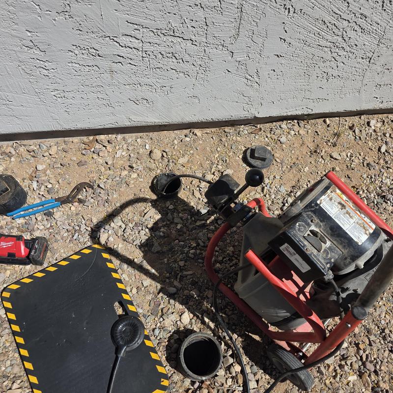 Main sewer line cleaning with plumbing snake machine