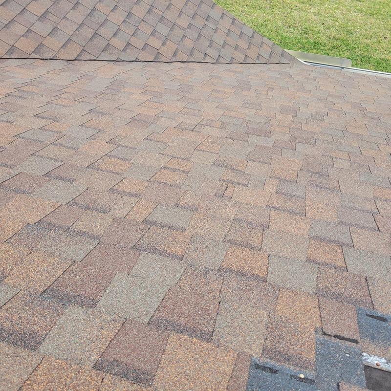 Shingle roof with visible damage and missing granules