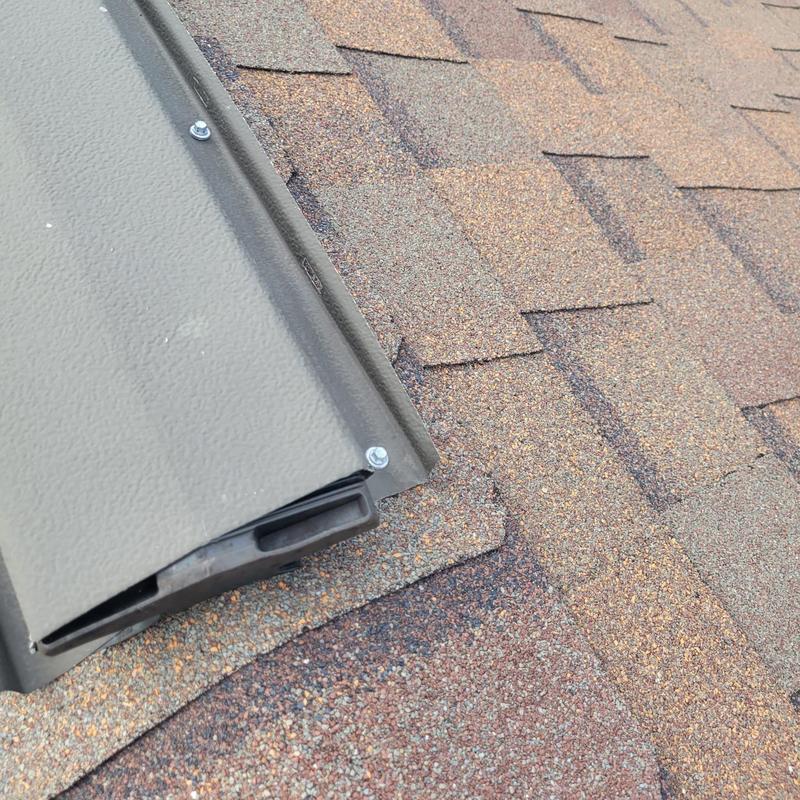 Shingle roof with improperly installed ridge vent screws
