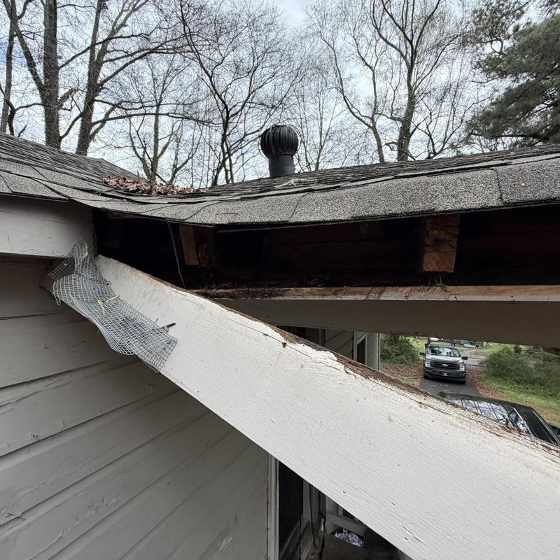Fascia and soffit with damaged framing exposed on roof edge
