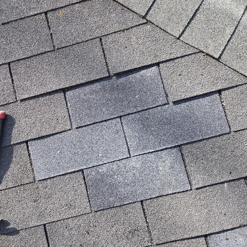 Shingles with replaced damaged decking board close-up