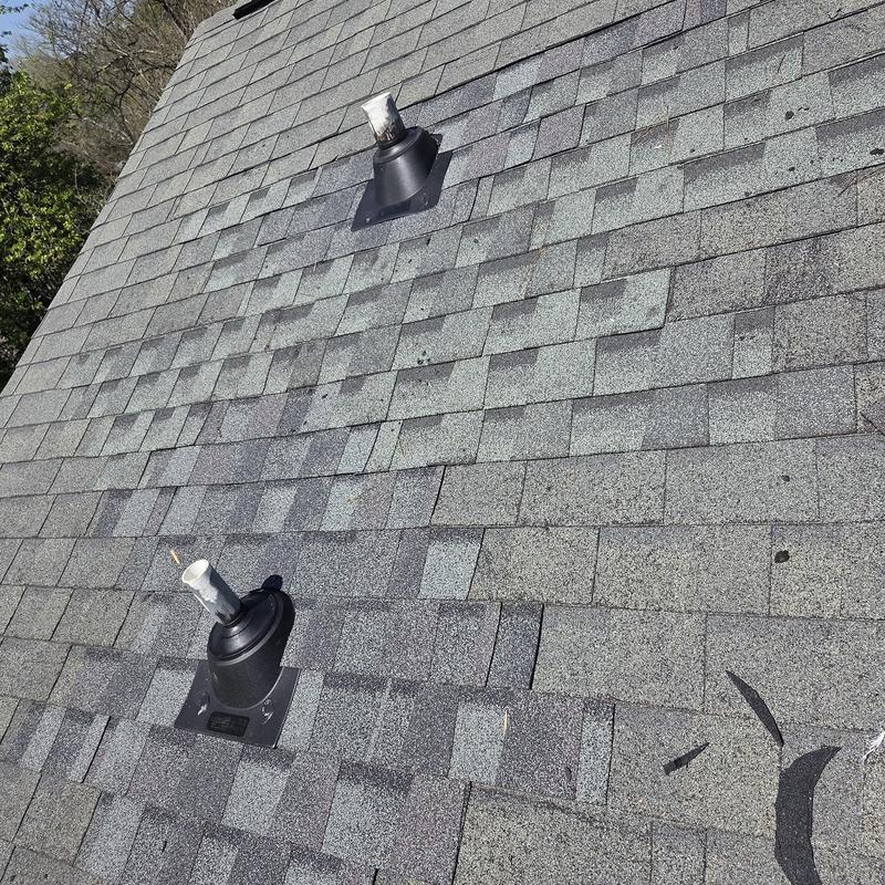 Pipe boots and surrounding asphalt shingles on roof