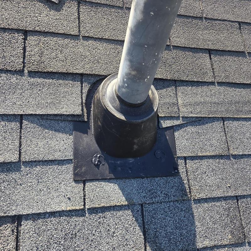 Pipe boot on asphalt shingle roof with caulked seal