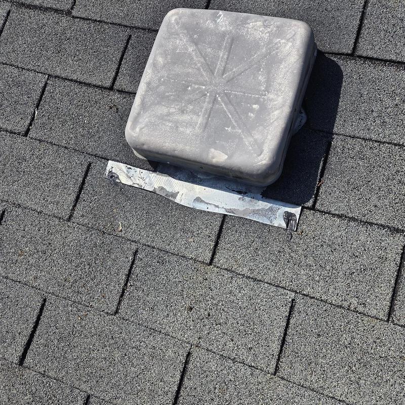 Roof vent pipe boot with damaged flashing on shingles