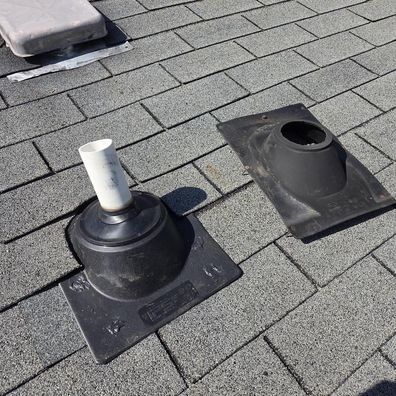 Pipe boots on shingled roof, one replaced and sealed.