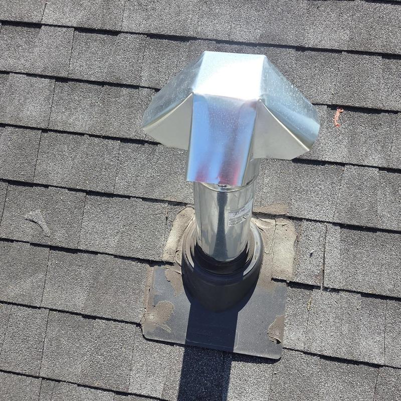 Metal rain cap and pipe boot on shingled roof